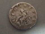 an old coin with a man riding a horse on it