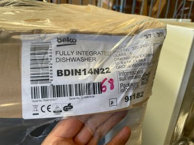 a person holding a box of food that is wrapped in plastic