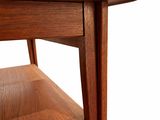 a close up of a wooden table with a shelf underneath it