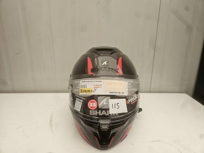 the helmet is black and red on a white table