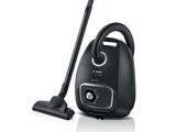 the vacuum is black and has a cord attached to it