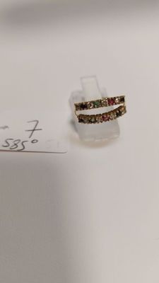 a small piece of jewelry sitting on top of a piece of paper