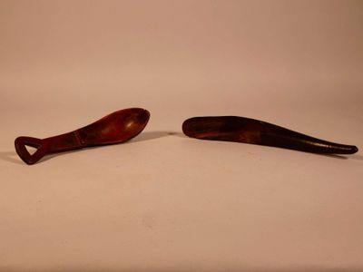 two wooden spoons sitting next to each other on a table