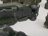 many toy army vehicles that are on a table
