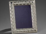 a silver picture frame with a blue glass in the center