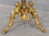 an image of a gold table with a clock on top of it