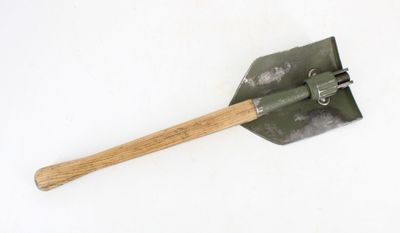a shovel with a wooden handle on a white surface