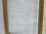 a gold picture frame sitting on top of a white table