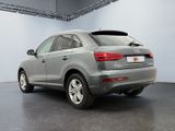 the rear of a silver audi qx parked in a garage