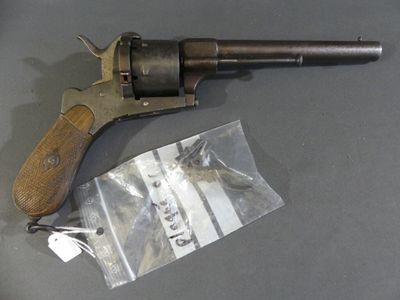 a gun that is sitting on a table next to a bag