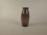 a small brown vase sitting on a white surface