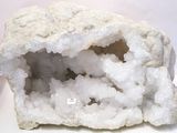 a white rock with a hole in it on a table