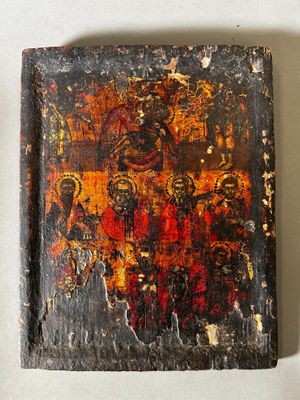 an old book with a painting on it sitting on top of a table
