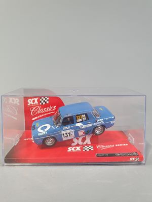 a blue toy car in a clear box on a table