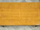 a close up of a wooden table on a tiled floor