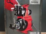 the box is open on the table with a small engine in it