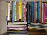 many books stacked on top of each other on a shelf