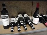 several bottles of wine are lined up on a shelf