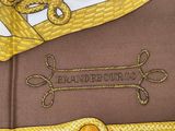 yellow and brown necktie with a braided edge and a name on it