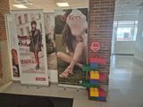 two large posters on the wall of a building