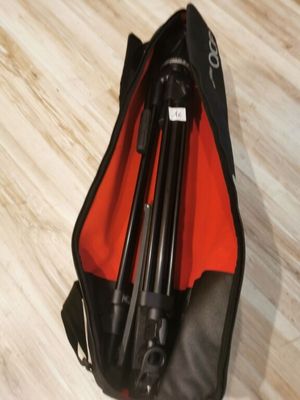 a bag with a tripod in it sitting on the floor