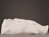 an image of a sculpture of a woman laying down on the ground