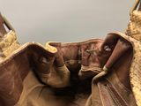 the inside of a brown purse with a zipper on it