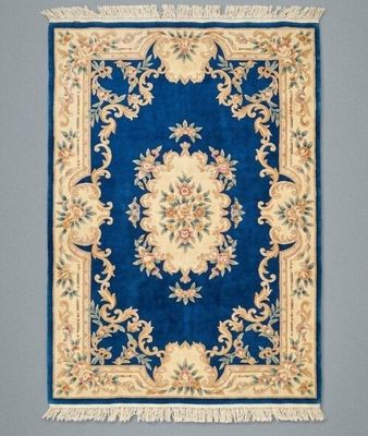 a close up of a blue rug with a floral design on it