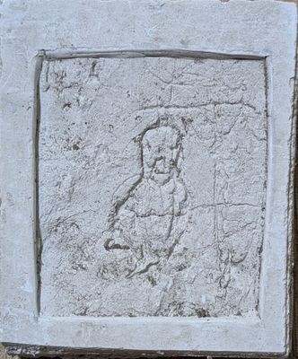 une plaque en pierre sur laquelle est représenté un chien