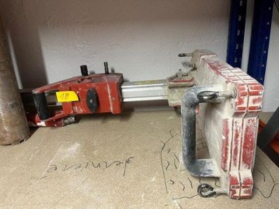 a clamp that is sitting on the floor next to a pipe cutter