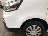 a close up of a white van parked in a parking lot