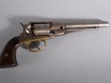 a close up of a revolver on a table with a white background