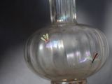 a glass vase with a small insect inside of it
