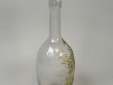 a clear glass bottle with a clear top on a white surface