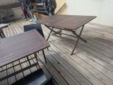 a table and chairs on the deck of a house