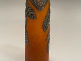 a small vase with a design on it on a white surface