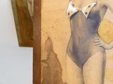 a painting of a woman in a bathing suit hanging on a wall