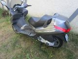 a motor scooter that is parked in the grass