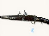 a gun that is on display on a white surface