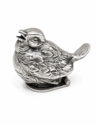 une figurine en argent représentant un oiseau tenant une cuillère dans le bec