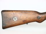 a close up of a rifle on a white surface with a white background