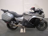 a silver motorcycle that is parked on a checkered floor