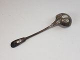 a spoon with a spoon handle on it on a table