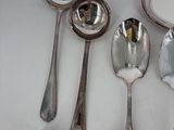 several silver spoons and spoon spoons sitting on top of a white table