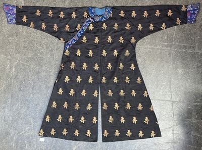 an image of a black jacket with gold and blue designs on it