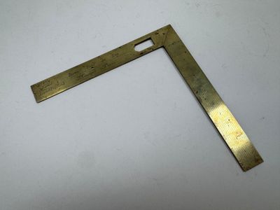 une plaque en laiton sur laquelle est posée une règle