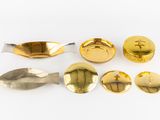 a lot of gold spoons and spoons on a white surface