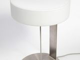 a white table lamp with a metal base and a white lamp shade