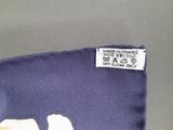 a close up of a label on a blue shirt