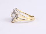 a close up of a diamond ring on a white surface
